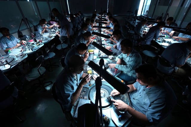 Employees cut and polish diamonds at Shree Ramkrishna Exports in Surat, India, on April 14, 2025.