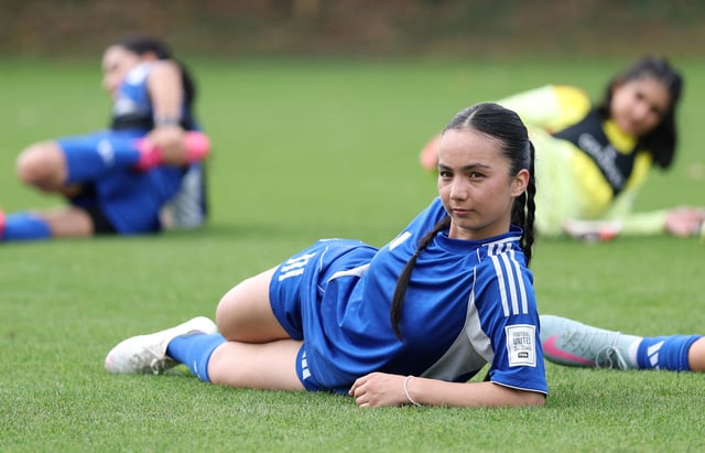Soccer Football - Najma Arefi of the Afghan Women's Refugee team stretches during a selection camp at St. George's Park, Burton upon Trent, Britain - August 26, 2025 REUTERS/John Sibley