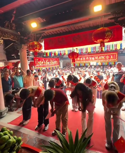 During the ceremony, the successful graduates, adorned in red sashes that read “The glory of our ancestral clan,” paid their respects by bowing before the memorial tablets of their ancestors. Photo: Jimu