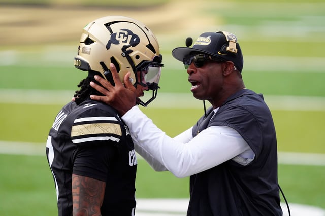 Colorado head coach Deion Sanders congratulates quarterback Kaidon Salter following a touchdown pass in the first quarter against Georgia Tech.