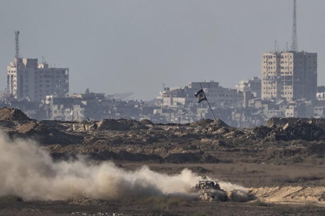An Israeli armored vehicle moves in an area in the Gaza Strip, as seen from southern Israel, Friday, Aug. 29, 2025. (AP Photo/Maya Levin)