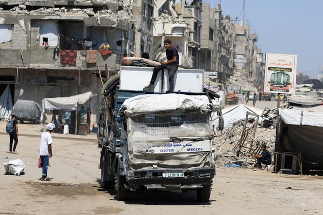 Displaced Palestinians ride on a vehicle loaded with belongings as they flee from one area to another within Gaza City, amid an Israeli military operation, in Gaza City, August 29, 2025. REUTERS/Dawoud Abu Alkas/File Photo