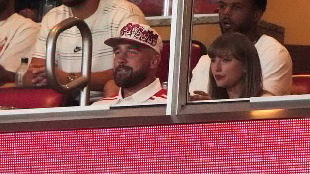 Taylor Swift, front right, sits with fiance Travis Kelce.