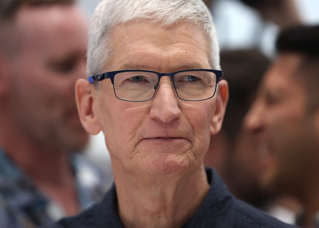 Apple CEO Tim Cook inspects the new iPhone 16 during an Apple special event at Apple headquarters on September 09, 2024 in Cupertino, California.