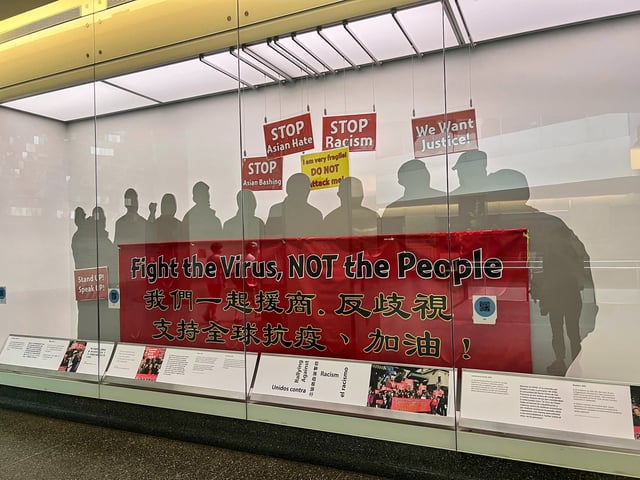A “Fight the Virus, Not the People” COVID-19 banner at the Smithsonian’s National Museum of American History on Aug. 13, 2025. The banner was carried by counter-protesters at an anti-Asian hate march in San Francisco in February 2020. It is the museum’s most recent collection related to the pandemic. (AP Photo/River Zhang)