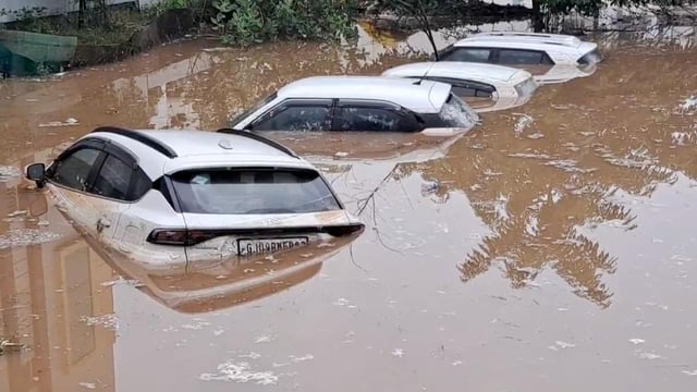 Cars submerged in floodwaters that entered residential societies in Himmatnagar, Gujarat.