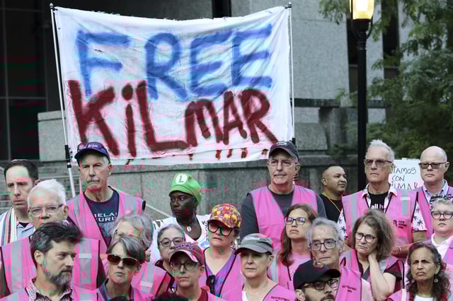 People attend a protest rally at the Immigration and Customs Enforcement field office in Baltimore, Monday, Aug. 25, 2025, to support Kilmar Abrego Garcia. (AP Photo/KT Kanazawich)