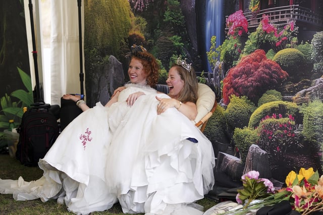 Two participants pose in a photo booth during the Red Head Days festival in Tilburg, Netherlands, Saturday, Aug. 30, 2025. (AP Photo/Virginia Mayo)