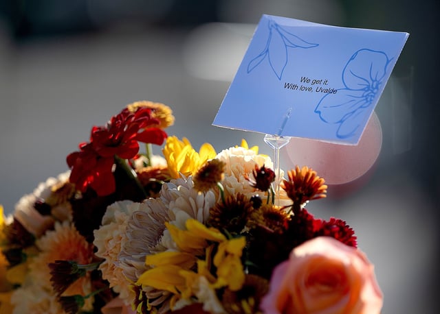 A note from Uvalde, Texas, where a 2022 school shooting took place, is part of a memorial near Annunciation Catholic Church on Thursday.