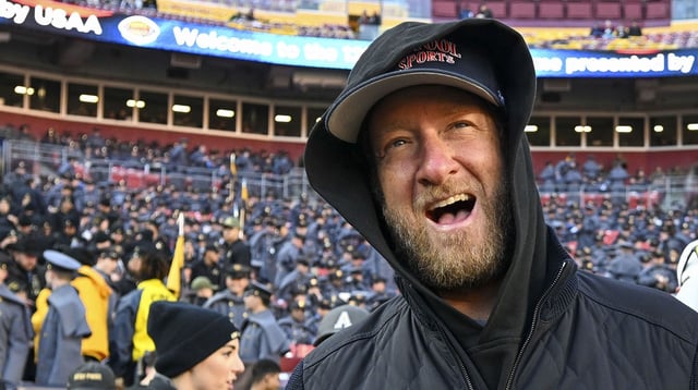 Dec 14, 2024; Landover, Maryland, USA; Dave Portnoy, Bar Stool Sports founder and owner walks along the sidelines before the playing of the 125 Army Navy game at Commanders Field. Mandatory Credit: Tommy Gilligan-Imagn Images Dec 14, 2024; Landover, Maryland, USA; Dave Portnoy poses with solders before the between the Army Black Knights and the Navy Midshipmen at Commanders Field. Mandatory Credit: Tommy Gilligan-Imagn Images