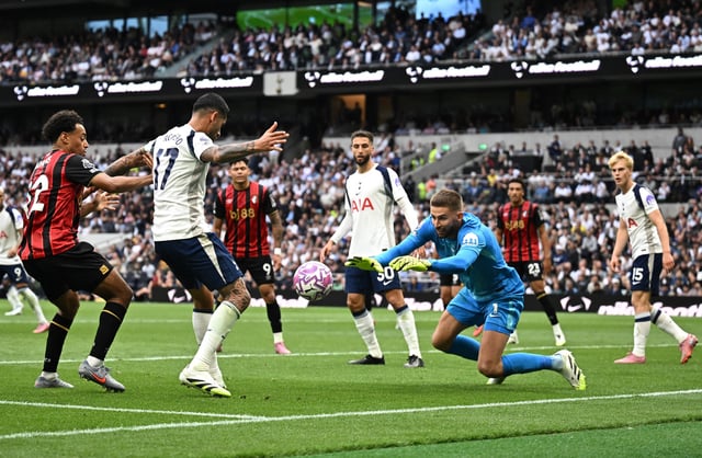Soccer Football - Premier League - Tottenham Hotspur v AFC Bournemouth - Tottenham Hotspur Stadium, London, Britain - August 30, 2025 Tottenham Hotspur's Guglielmo Vicario makes a save as Cristian Romero and AFC Bournemouth's Tyler Adams look on REUTERS/Dylan Martinez