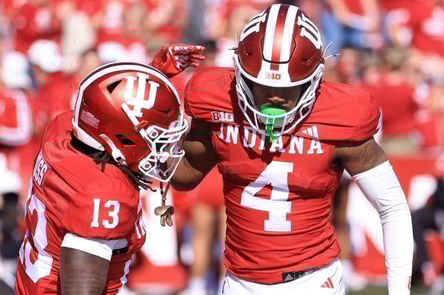 Myles Price #4 of the Indiana Hoosiers reacts with Cedarius Doss #13 in the game against the Washington Huskies at Memorial Stadium on October 26, 2024 in Bloomington, Indiana.