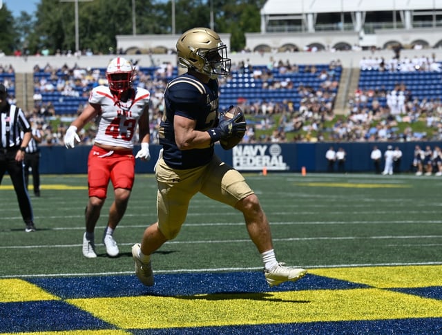 Navy’s Eli Heidenreich catches a Blake Horvath pass for a touchdown in the second quarter. The Navy Midshipmen play their NCAA football season opener at home against the visiting VMI Keydets at Navy-Marine Corps Memorial Stadium in Annapolis. (Paul W. Gillespie/Staff)