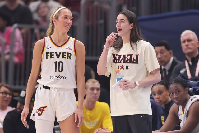 Lexie Hull #10 and Caitlin Clark #22 of the Indiana Fever confer against the Chicago Sky during the first half at the United Center on July 27, 2025 in Chicago, Illinois.