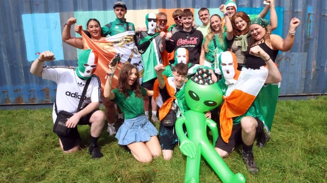 Fans of Kneecap wore tricolour balaclavas, above