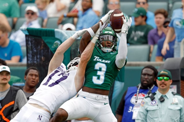 Tulane defensive back Javion White intercepts a pass in front of Northwestern wide receiver Griffin Wilde at Yulman Stadium on Aug. 30, 2025, in New Orleans. (Tyler Kaufman/Getty Images)
