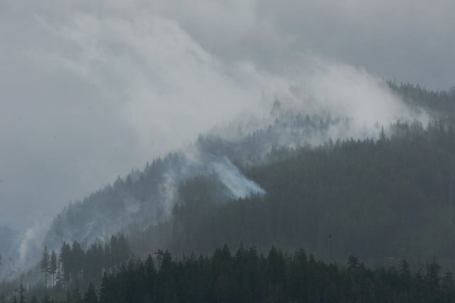 Rain and smoke from the Mount Underwood wildfire is seen, south of Port Alberni, B.C., on Saturday, Aug. 16, 2025. THE CANADIAN PRESS/Chad Hipolito