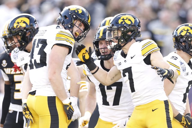 Isaac Thompson #43 and John Nestor #7 of the Iowa Hawkeyes celebrate after a defensive play during the first half of the Transperfect Music City Bowl against the Missouri Tigers at Nissan Stadium on December 30, 2024 in Nashville, Tennessee.
