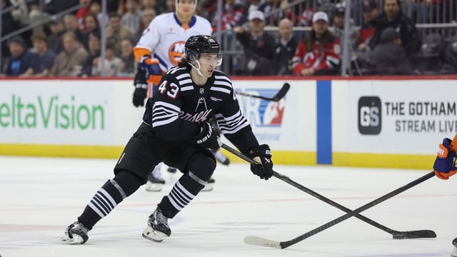 Apr 13, 2025; Newark, New Jersey, USA; New Jersey Devils defenseman Luke Hughes (43) skates with the puck against the New York Islanders during the second period at Prudential Center. Mandatory Credit: Ed Mulholland-Imagn Images