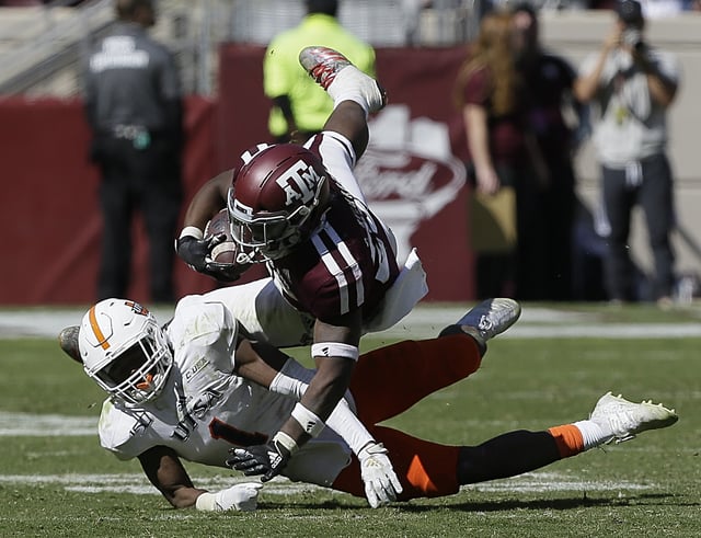 Cordarrian Richardson #25 of the Texas A&M Aggies is tackled by Kelechi Nwachuku #1 of the UTSA Roadrunners during the fourth quarter at Kyle Field on November 02, 2019 in College Station, Texas.