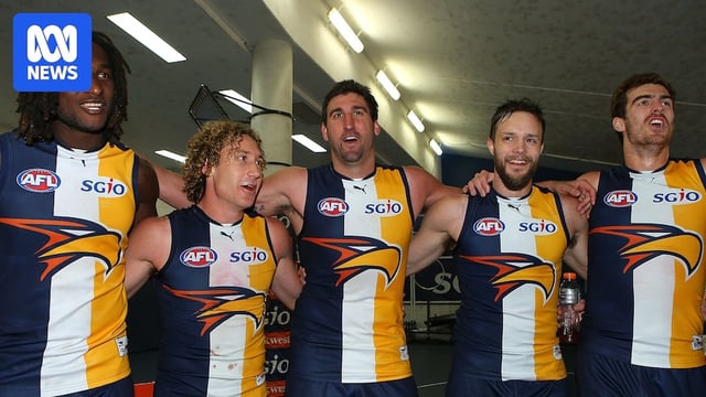 Nic Naitanui, Matt Priddis, Dean Cox, Mitchell Brown and Scott Lycett stand arm in arm singing West Coast Eagles' AFL team song.