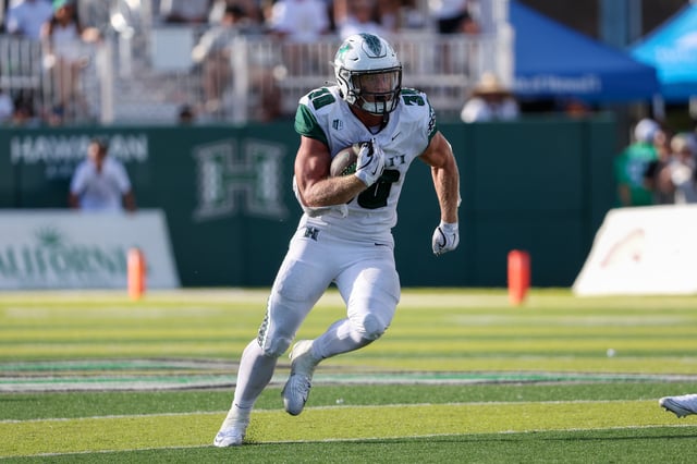 Landon Sims #30 of the Hawaii Rainbow Warriors runs the ball during the second half against the Stanford Cardinal at the Clarence T.C. Ching Athletics Complex on August 23, 2025 in Honolulu, Hawaii.