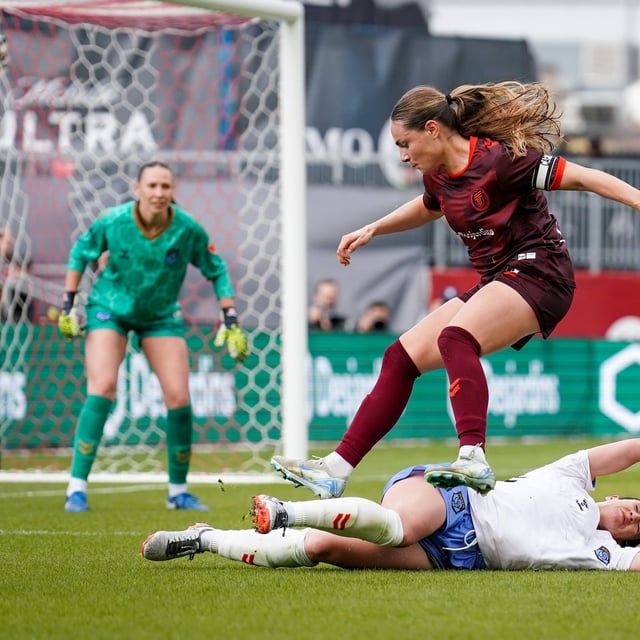 AFC Toronto defender Emma Regan (8) jumps over Montreal Roses FC Defender Lucy Cappadona (2) during second half Northern Super League soccer action in Toronto on Saturday, April 19, 2025. THE CANADIAN PRESS/Arlyn McAdorey
