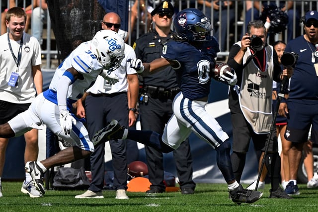 UConn running back Cam Edwards (0) runs for a 73 yard touchdown while pursued by Central Connecticut defensive back Deonte Douglas (38) during an NCAA college football game at Pratt & Whitney Stadium at Rentschler Field in East Hartford, Saturday, Aug. 30, 2025. (Jessica Hill/Special to the Courant)
