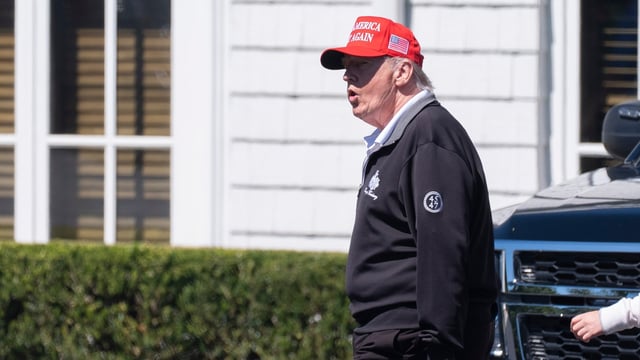 President Donald Trump walks at the Trump National Golf Club in Sterling, Va., Saturday. 