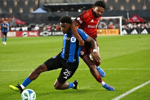 Toronto FC's Kosi Thompson, right, tackles CF Montreal's Dante Sealy (25) during first half MLS soccer action in Toronto on Saturday, Aug. 30, 2025. THE CANADIAN PRESS/Jon Blacker
