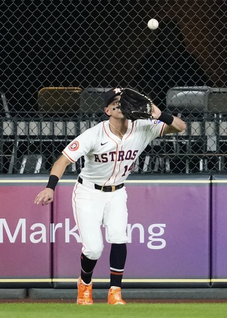 Houston Astros center fielder Mauricio Dubon catches a fly ball hit by Los Angeles Angels' Yoan Moncada during the first inning of a baseball game in Houston, Saturday, Aug. 30, 2025. (AP Photo/Ashley Landis)