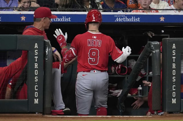 Los Angeles Angels' Zach Neto returns to the dugout after hitting a home run during the third inning of a baseball game against the Houston Astros in Houston, Saturday, Aug. 30, 2025. (AP Photo/Ashley Landis)