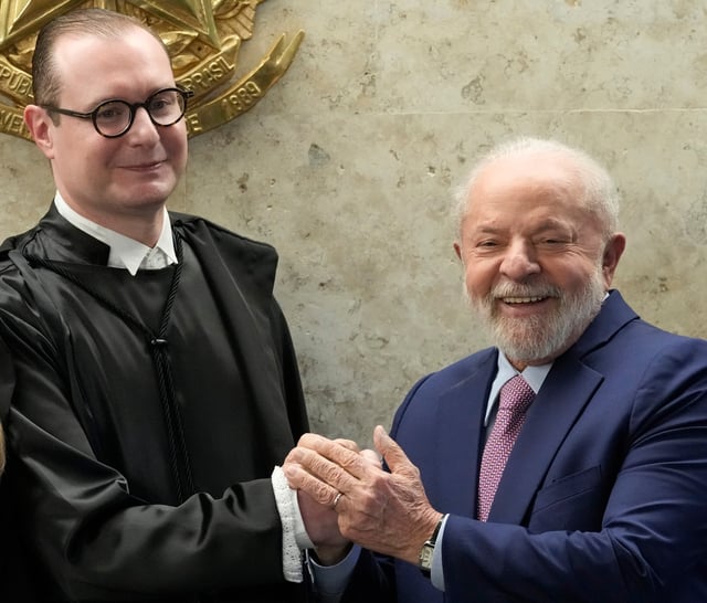 FILE - Brazil's President Luiz Inacio Lula da Silva, right, and new Supreme Court Justice Cristiano Zanin, pose for photos after his swearing-in ceremony, in Brasilia, Brazil, Aug. 3, 2023. (AP Photo/Eraldo Peres, File)