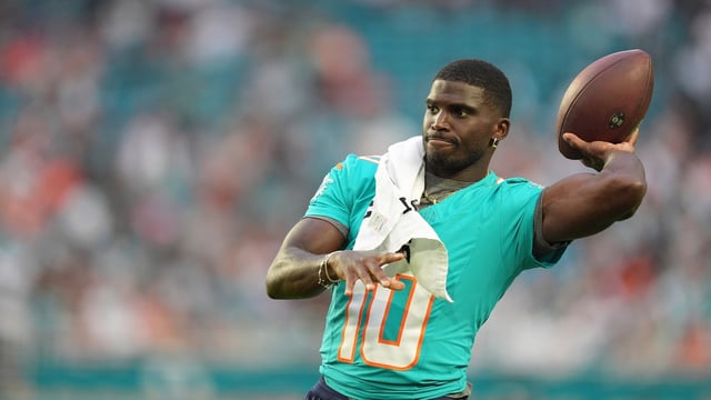 Miami Dolphins wide receiver Tyreek Hill (10) throws the football on the sidelines during the first half of an NFL preseason football game against the Jacksonville Jaguars, Saturday, Aug. 23, 2025, in Miami Gardens, Fla.