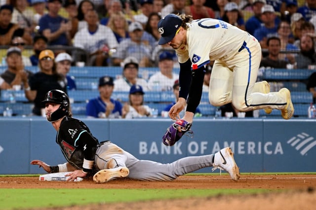 Arizona Diamondbacks Blaze Alexander slides safely into third base as Dodgers third baseman Enrique Hernández tries to apply the tag in the ninth inning of a baseball game Saturday, Aug. 30, 2025, in Los Angeles. (AP Photo/Wally Skalij)