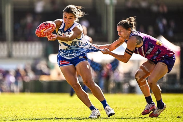 Ash Riddell of the Kangaroos is tackled by Kiara Bowers.