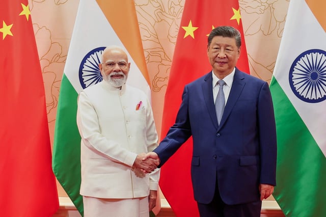 Indian Prime Minister Narendra Modi, left, and Chinese President Xi Jinping shake hands before their meeting on the sidelines of the Shanghai Cooperation Organization (SCO) summit in Tianjin, China on Sunday, August 31.