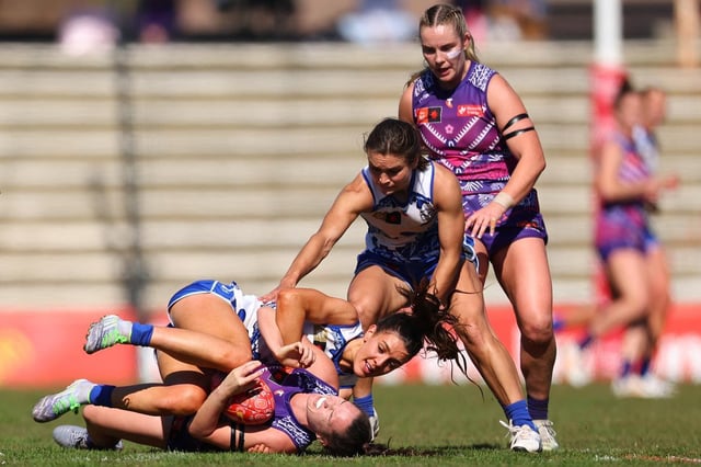 Erika O'Shea of the Kangaroos tackles Freo’s Philipa Seth.