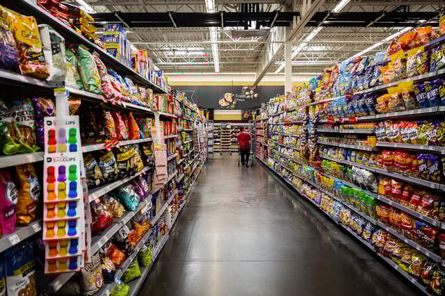 Customer with shopping cart in the snack aisle of a Walmart store in Florida City in the state of Florida in the United States of America (USA) on August 5, 2025.