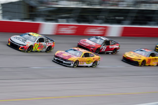 William Byron (24) and Joey Logano (22) lead the field on a restart out of Turn 1 during the 2025 Goodyear 400 at Darlington Raceway.