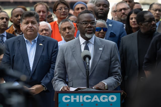 Flanked by Illinois Gov. JB Pritzker, left, and other Illinois politicians and community leaders, Chicago Mayor Brandon Johnson speaks at an Aug. 25, 2025, news conference to address President Donald Trump's plan to send National Guard troops into the city.