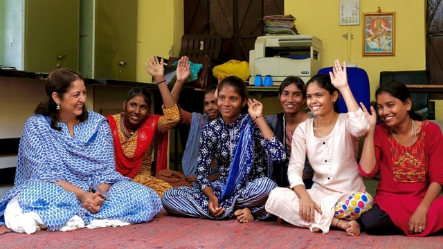 Safeena Husain, left, founder and board member of the Foundation to Educate Girls talks to a group in Rajasthan, India. 