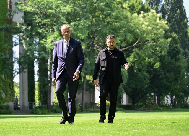 Ukrainian President Volodymyr Zelenskiy  is welcomed by German Chancellor Friedrich Merz upon arrival in the garden of the chancellery in Berlin to join a video conference of European leaders with the US President on the Ukraine war ahead of the summit between the US and Russian leaders, on August 13, 2025. JOHN MACDOUGALL/Pool via REUTERS/File Photo