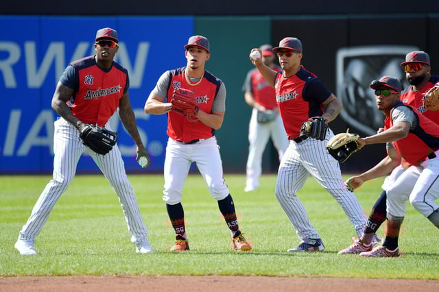 (L-R) Aroldis Chapman #54 of the New York Yankees and the American League, Jose Berrios #17 of the Minnesota Twins and the American League, Gleyber Torres #25 of the New York Yankees and the American League, Jorge Polanco #11 of the Minnesota Twins and the American League, and Carlos Santana #41 of the Cleveland Indians react to a ball during batting practice prior to the 2019 MLB All-Star Game on July 09, 2019 in Cleveland.