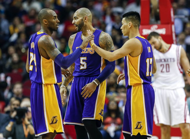 Los Angeles Lakers guard Kobe Bryant (24) and guard Jeremy Lin (17) react after a play during the second quarter against the Houston Rockets at Toyota Center.