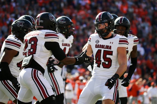 Colin Bryant #45 of the South Carolina Gamecocks reacts with Gerald Kilgore #23 of the South Carolina Gamecocks after a play against the Clemson Tigers at Memorial Stadium on November 30, 2024 in Clemson, South Carolina.