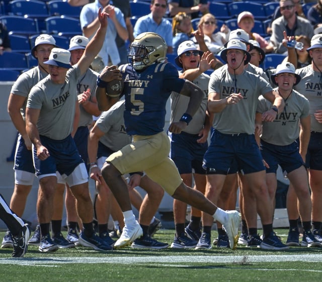 Navy backup quarterback Braxton Woodson breaks a huge run for a touchdown in the fourth quarter. The Navy Midshipmen win their NCAA football season opener at home against the visiting VMI Keydets, 52-7, at Navy-Marine Corps Memorial Stadium in Annapolis. (Paul W. Gillespie/Staff)