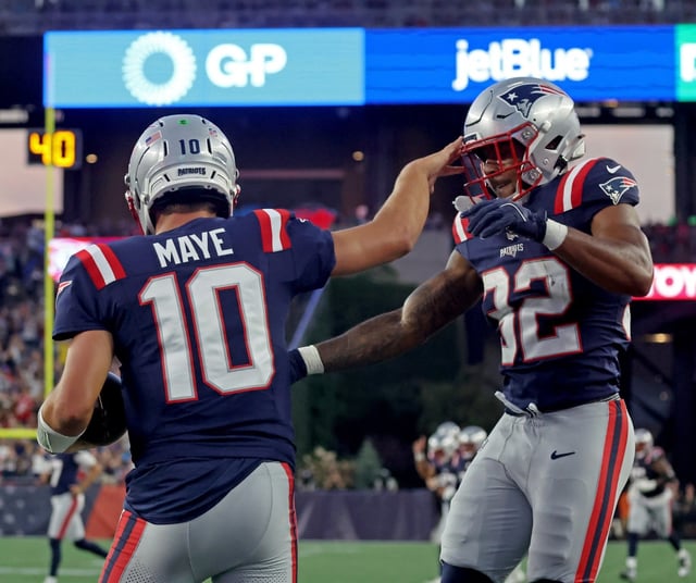 New England Patriots running back TreVeyon Henderson (32) congratulates quarterback Drake Maye on his TD as the Patriots take on the Commanders in preseason action. (Staff Photo By Stuart Cahill/Boston Herald)