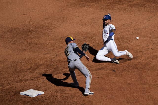 Aug 31, 2025; Toronto, Ontario, CAN; Toronto Blue Jays outfielder Nathan Lukes (38) attempts to steal second base against Milwaukee Brewers second baseman Brice Turang (2) at Rogers Centre. Mandatory Credit: Kevin Sousa-Imagn Images