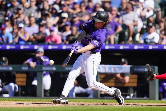 Aug 31, 2025; Denver, Colorado, USA; Colorado Rockies outfielder Mickey Moniak (22) hits a walk off triple in the ninth inning against the Chicago Cubs at Coors Field. Mandatory Credit: Ron Chenoy-Imagn Images